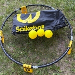 spikeball kit with net, yellow balls, and black bag.