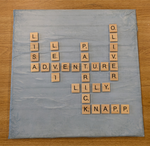 Canvas with scrabble tiles glued to it to spell out words