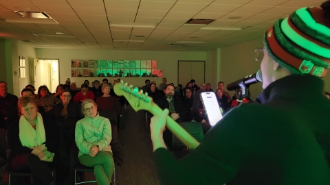 guitar player in front of a crowd