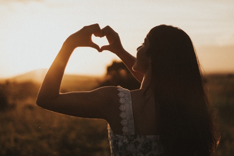 woman making heart shape with her hands