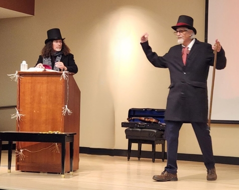 Two men in period costume presenting and acting