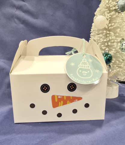 White box with snowman face pictured in front of white background