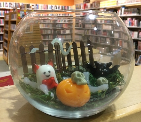 Halloween terrarium with mini pumpkin, skulls, ghost, and bat