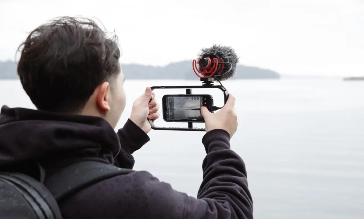 a man shooting video with smartphone