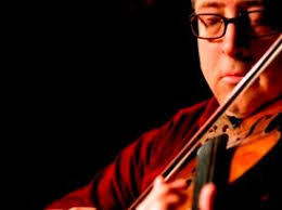 close up on Sean Cleland playing the fiddle