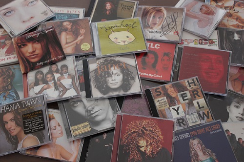 CDs of '90s artists scattered on a table